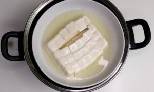 Silken tofu releases water after steaming.